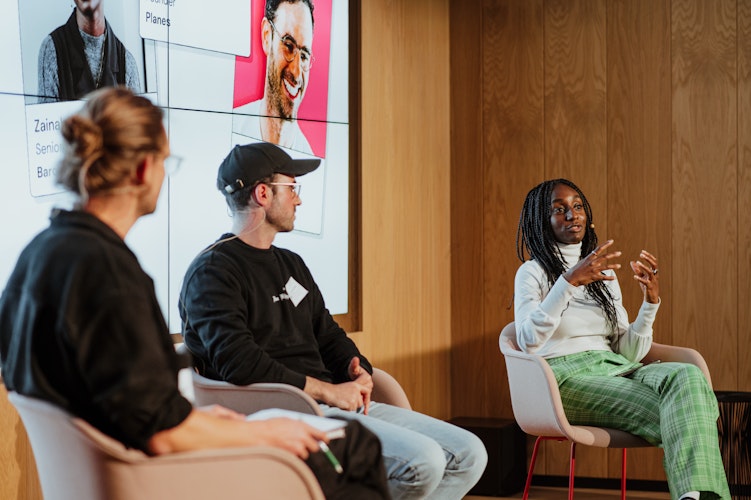 A group of people sitting in chairs in front of a tv screen. A group of people sitting in chairs in front of a tv screen.