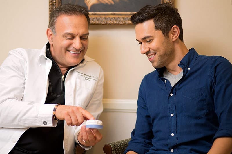 Dr. Maddahi with a male patient