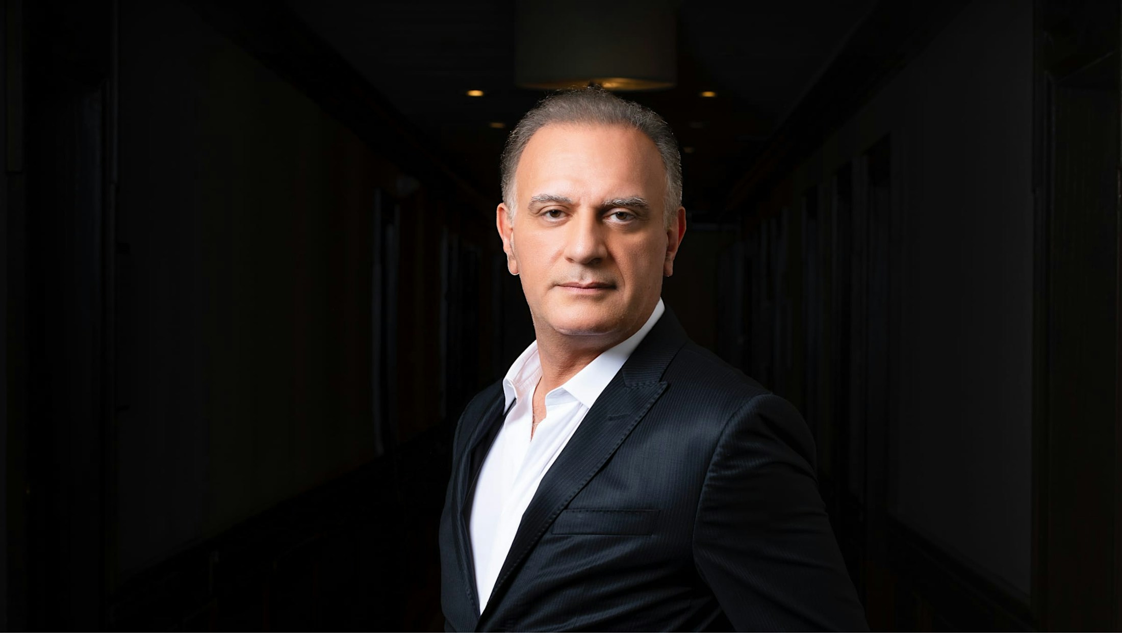 Dr. Maddahi in a dark suit.