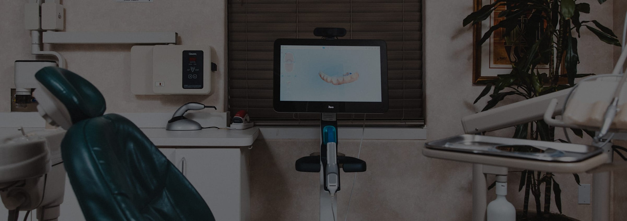 image of patient room with chair and dental instruments on a stand.