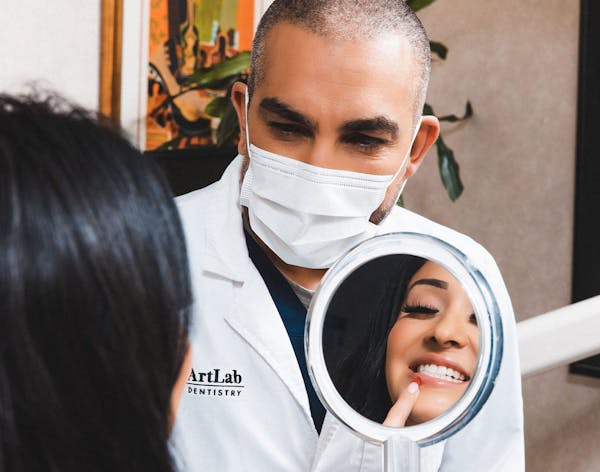 doctor showing a patient their smile transformation results