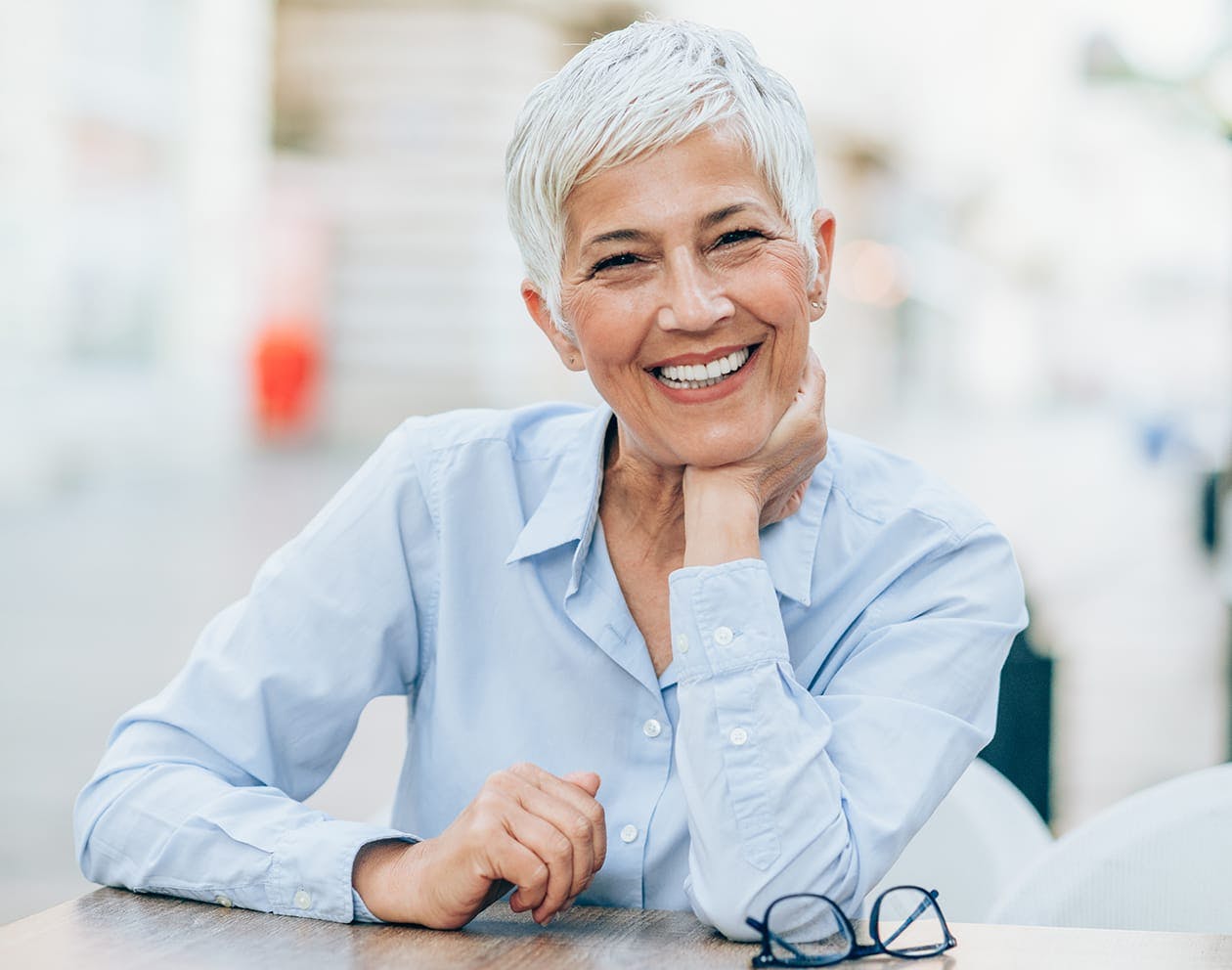 older woman wearing a light blue buttondown