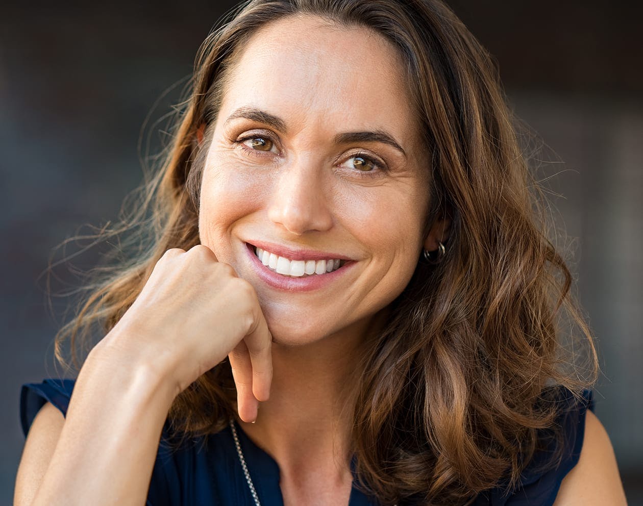 woman with long brunette hair wearing a black top