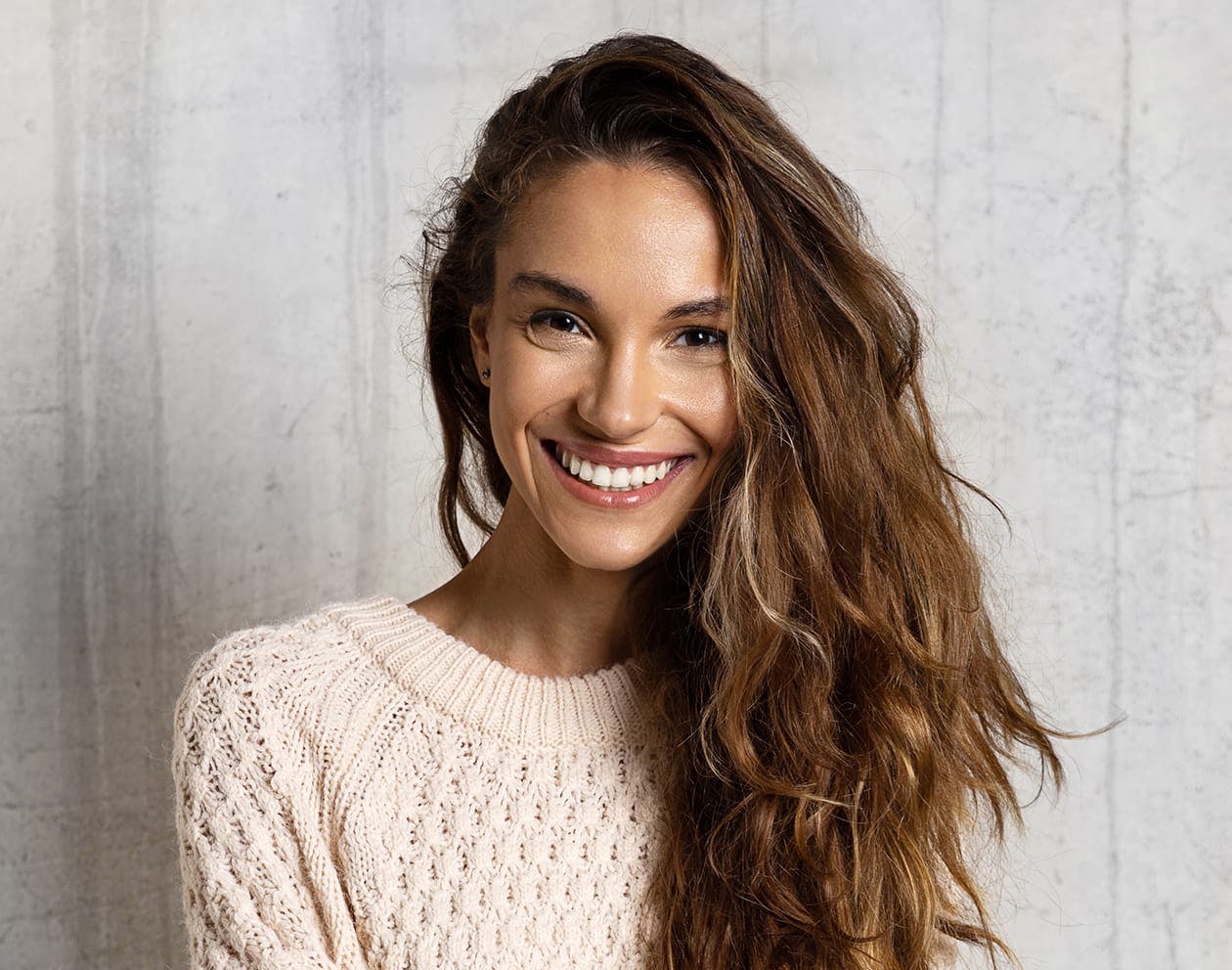 woman with dark brunette hair smiling