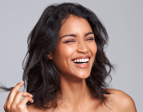 woman with dark hair smiling