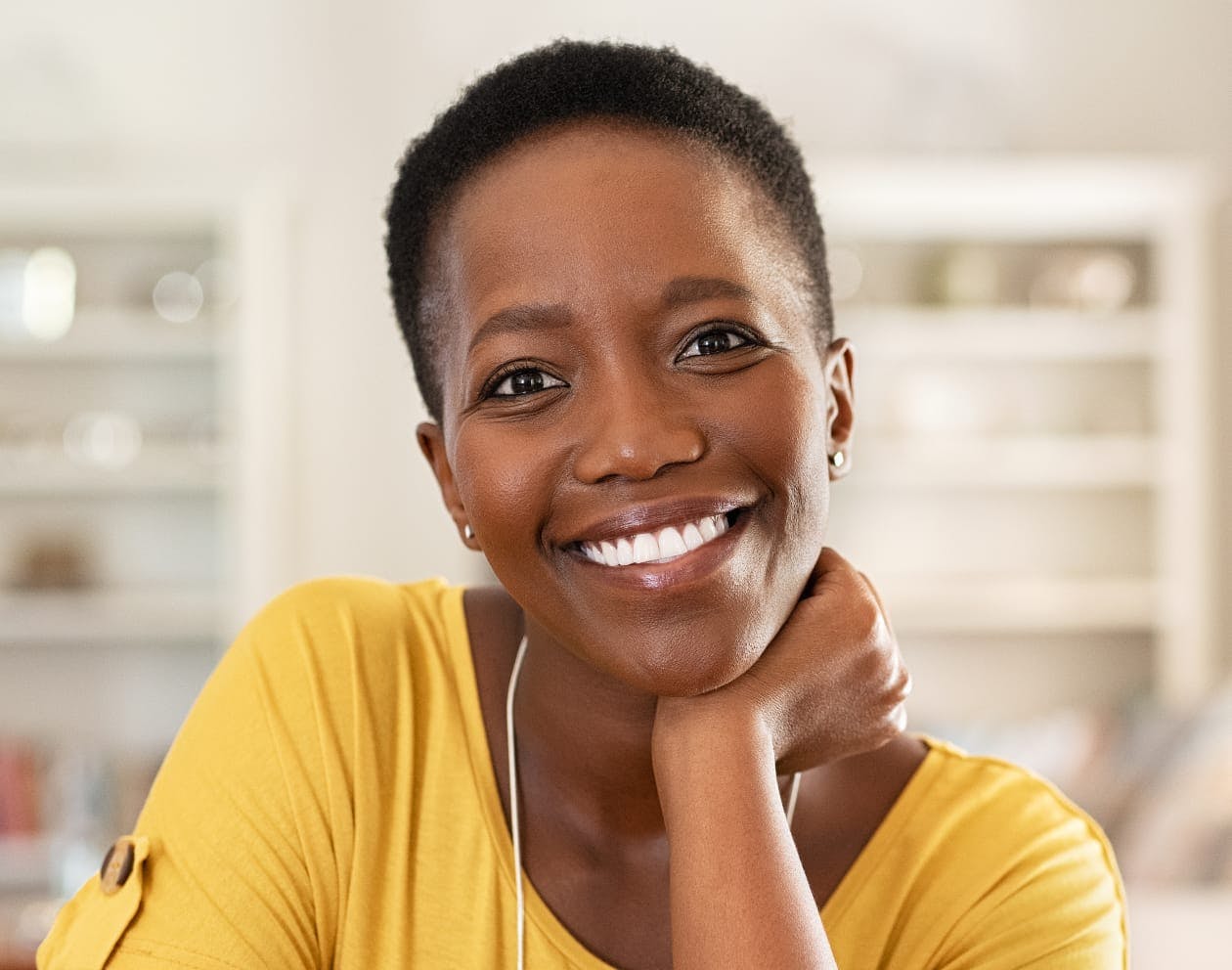 woman smiling in yellow top