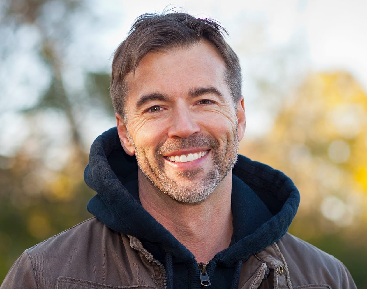 a older man wearing a black hoodie and jacket