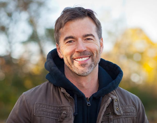 a older man wearing a black hoodie and jacket