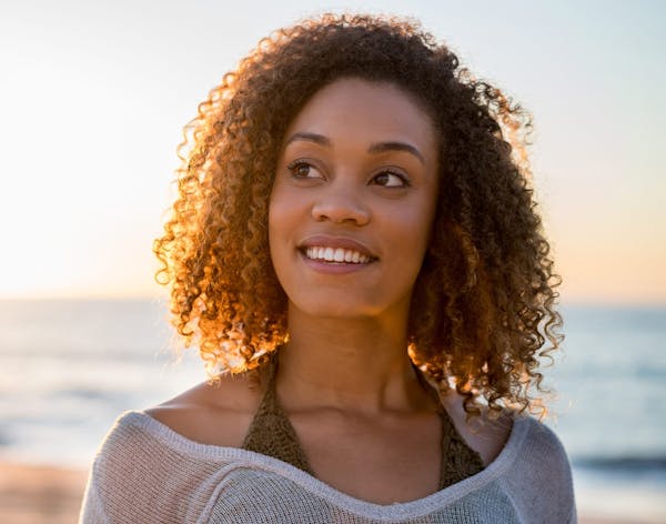 a headshot of a woman on the beach