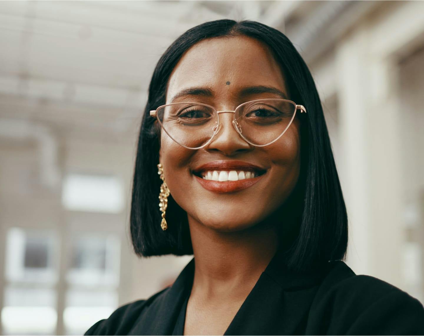 Woman wearing glasses and smiling,