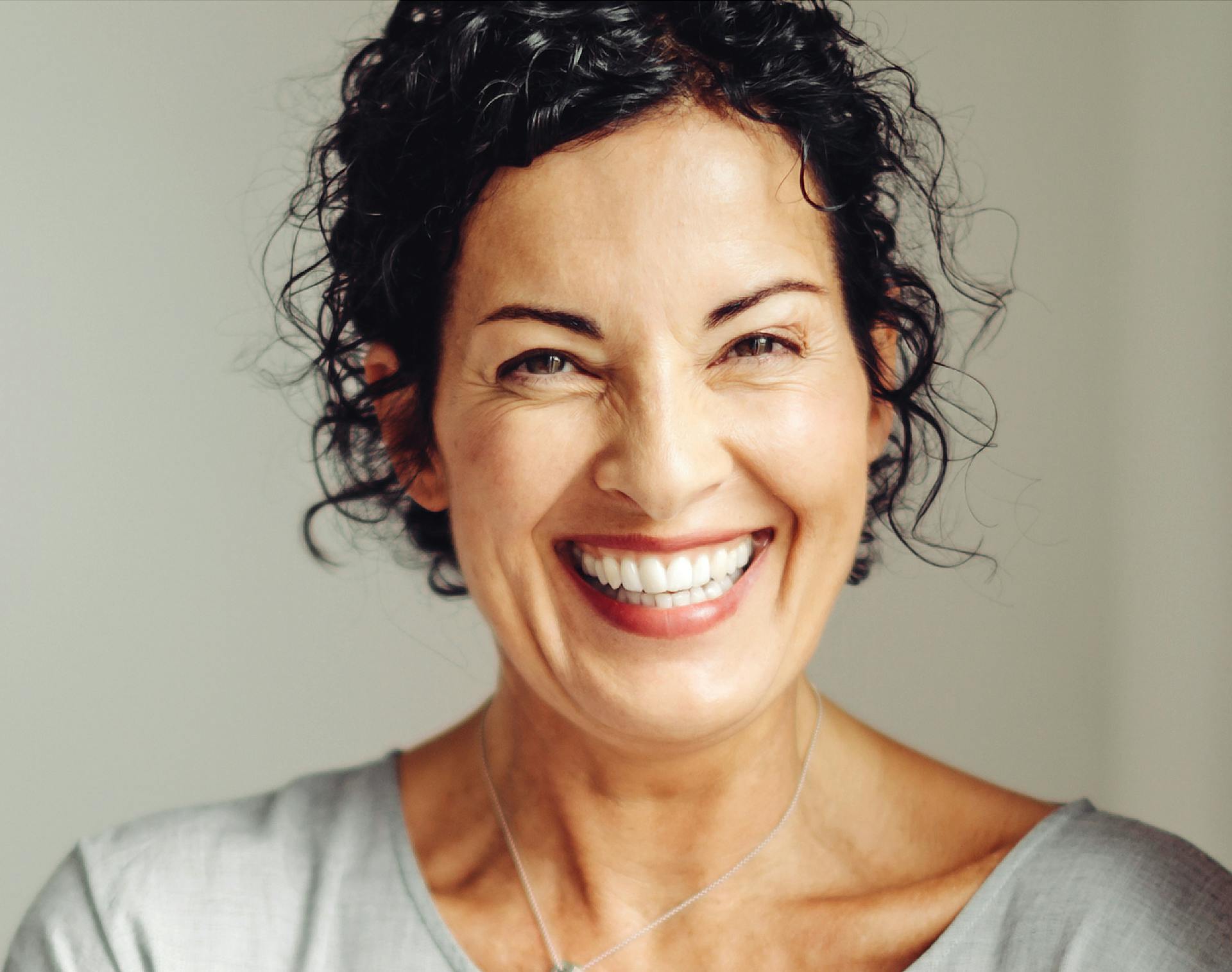 Middle-age woman smiling. 