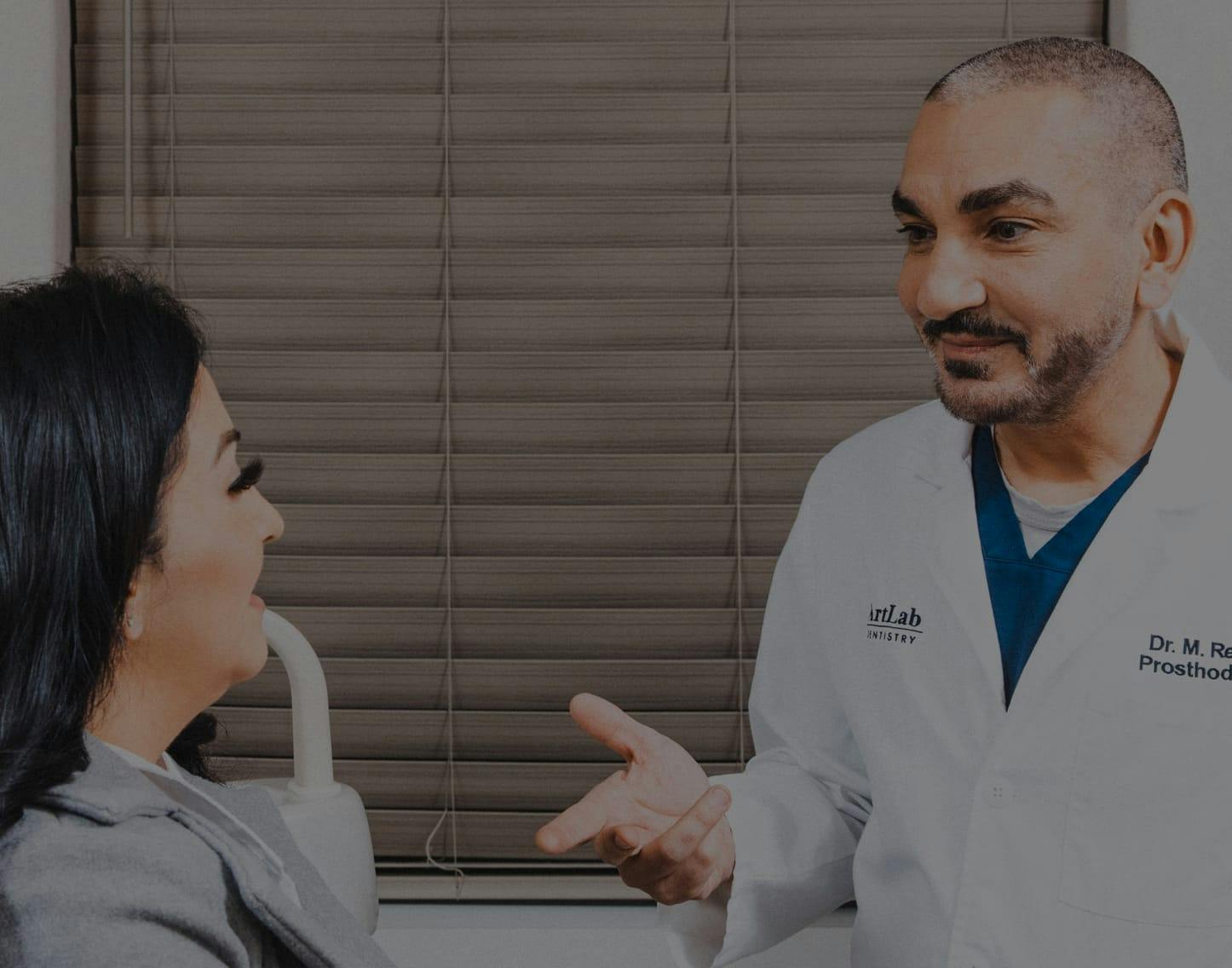 Dr. Reshad in lab coat smiling