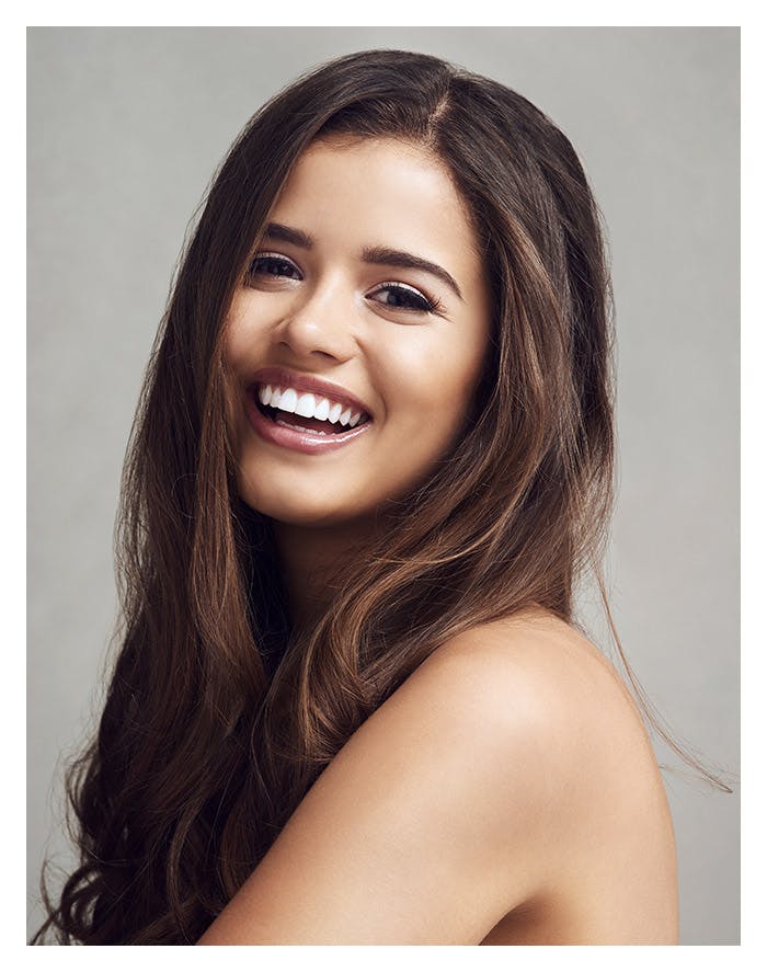 brunette model smiling really big at the camera