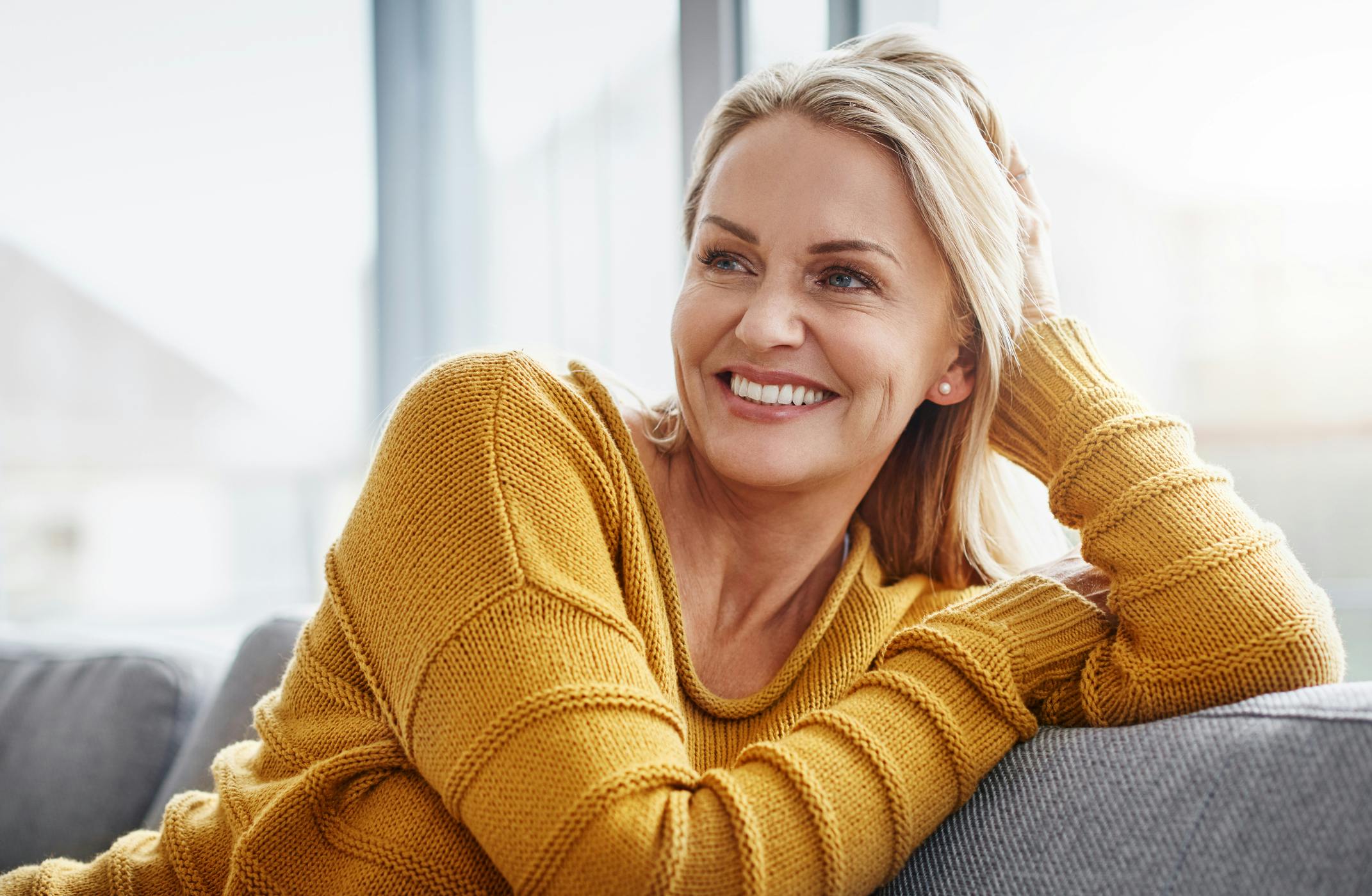 middle aged model in yellow sweater
