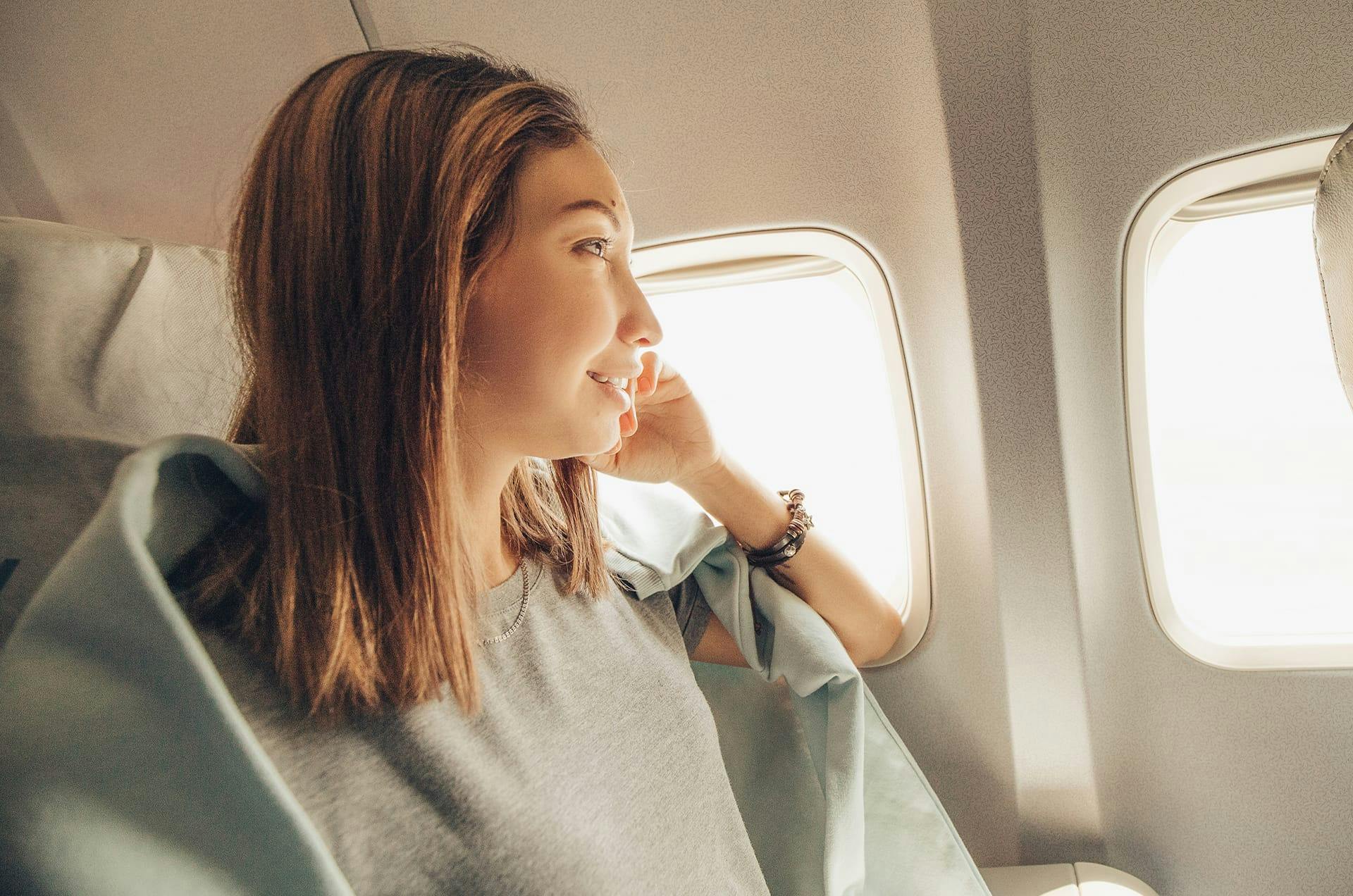 Woman looking out an airplane window