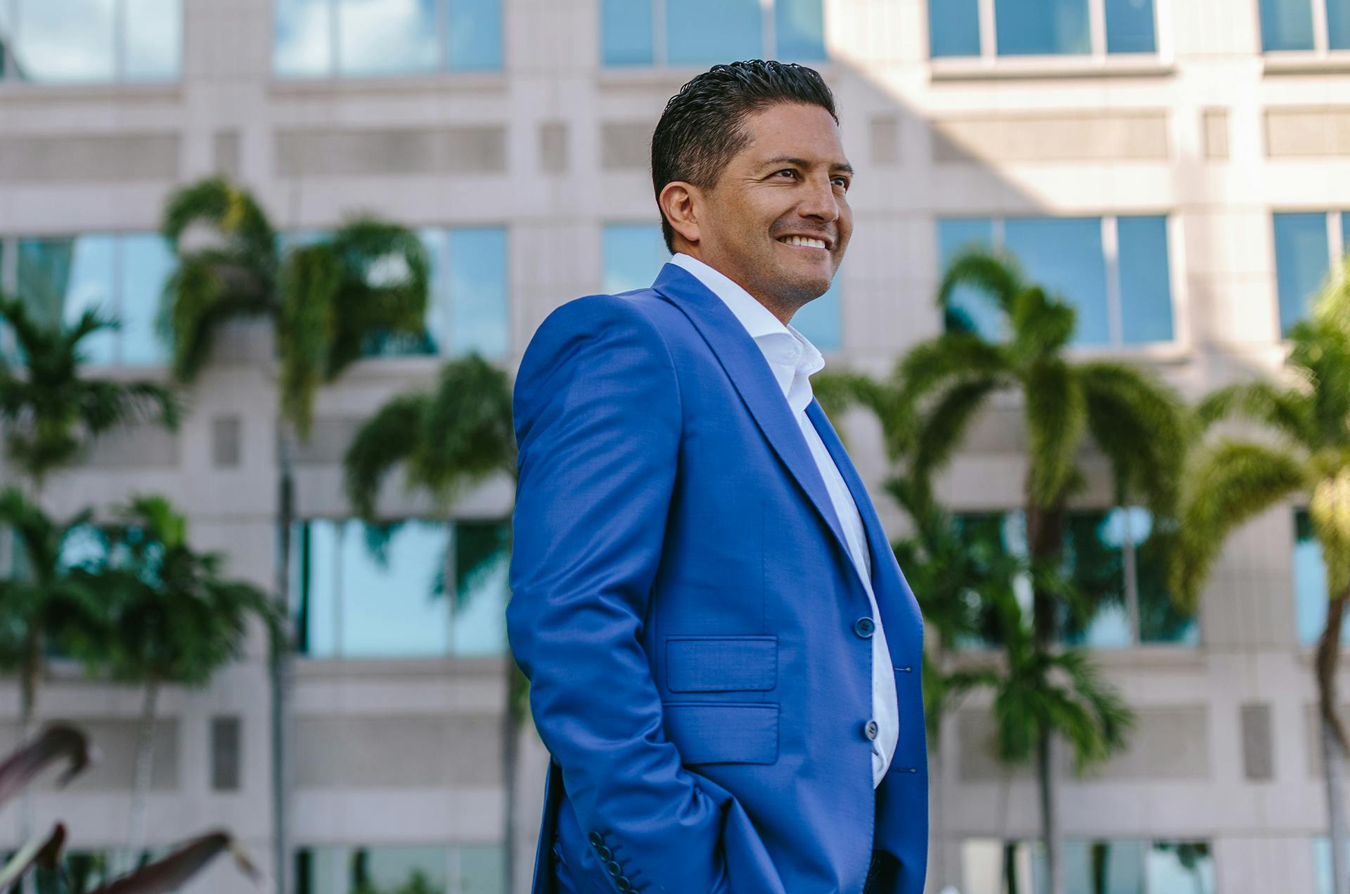 Dr. Espinoza in a suit, standing outside