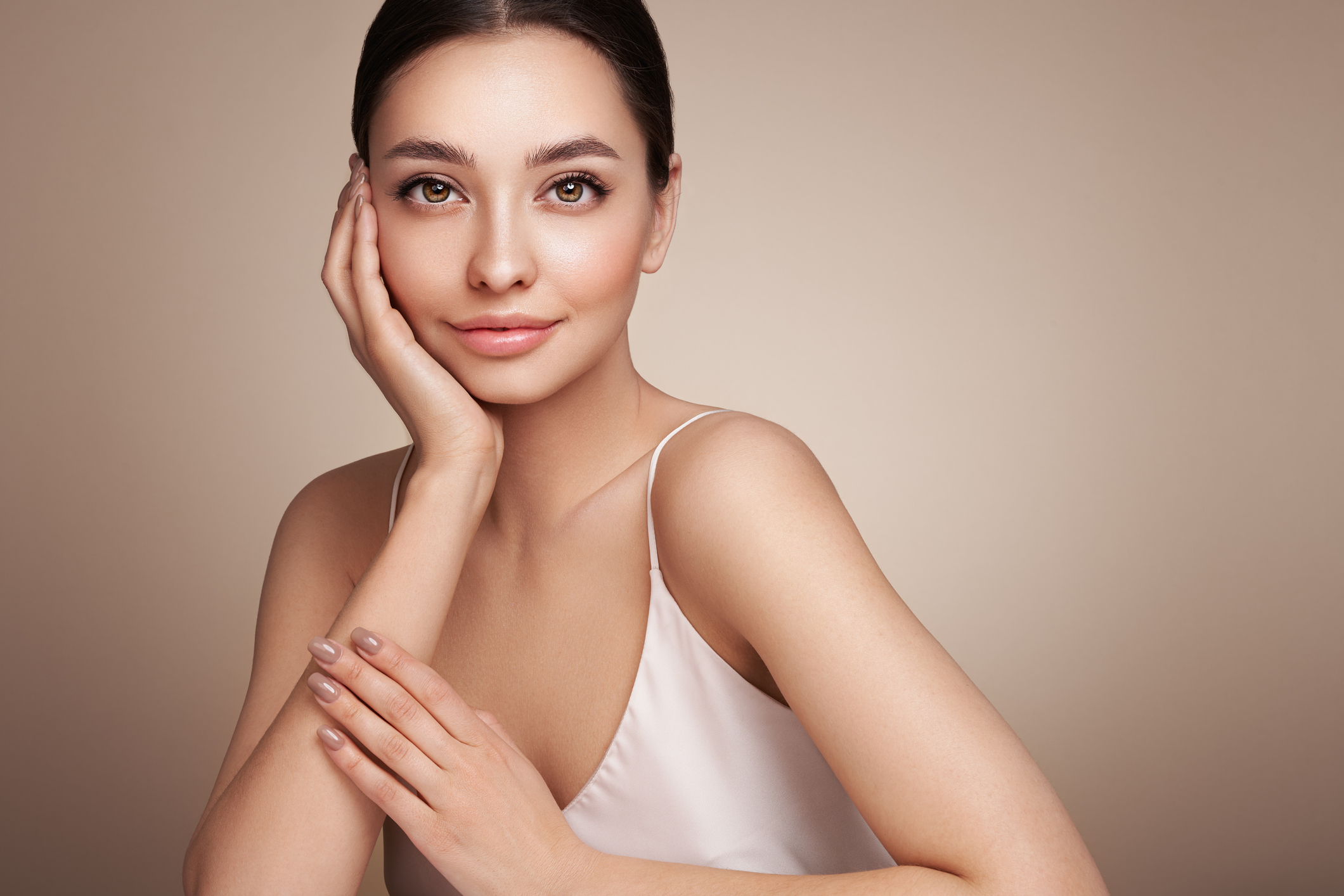 Beautiful woman posing with her hand holding her face