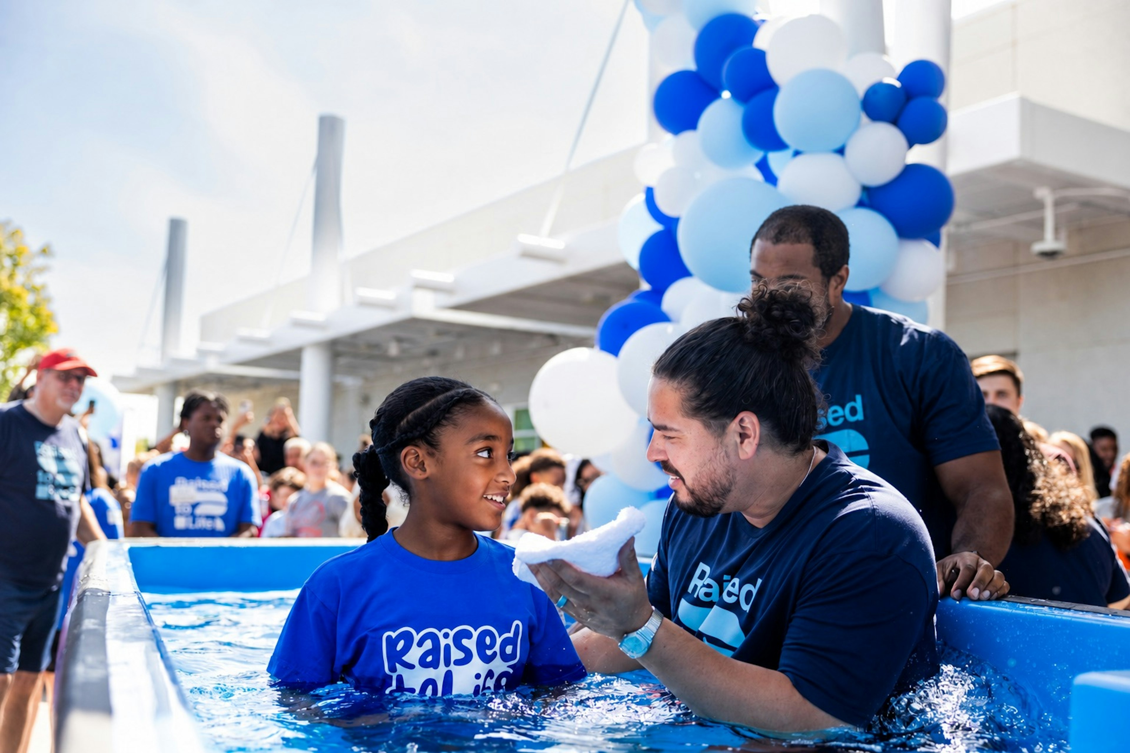eKid being baptized by a pastor