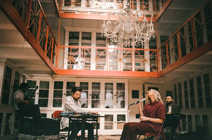 Tiffany and her band are seated under a beautiful chandelier, worshipping