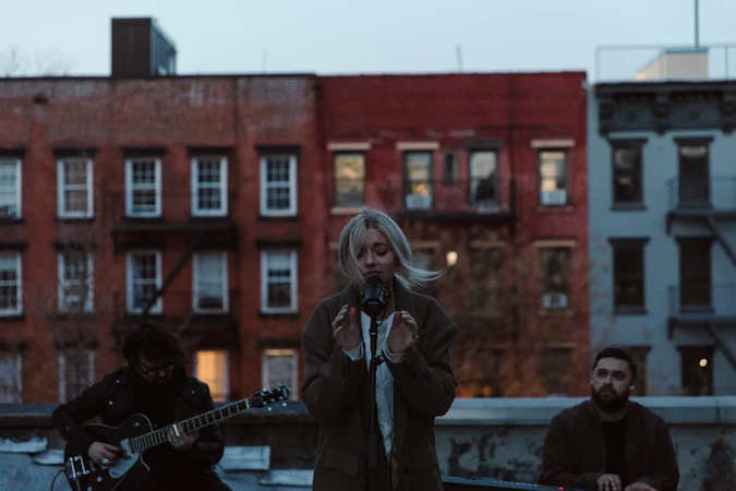 Tiffany and her band perform on a rooftop as the wind blowd