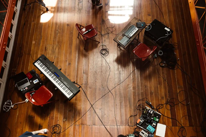 Bird's eye view of a room with hardwood floors, full of band equipment