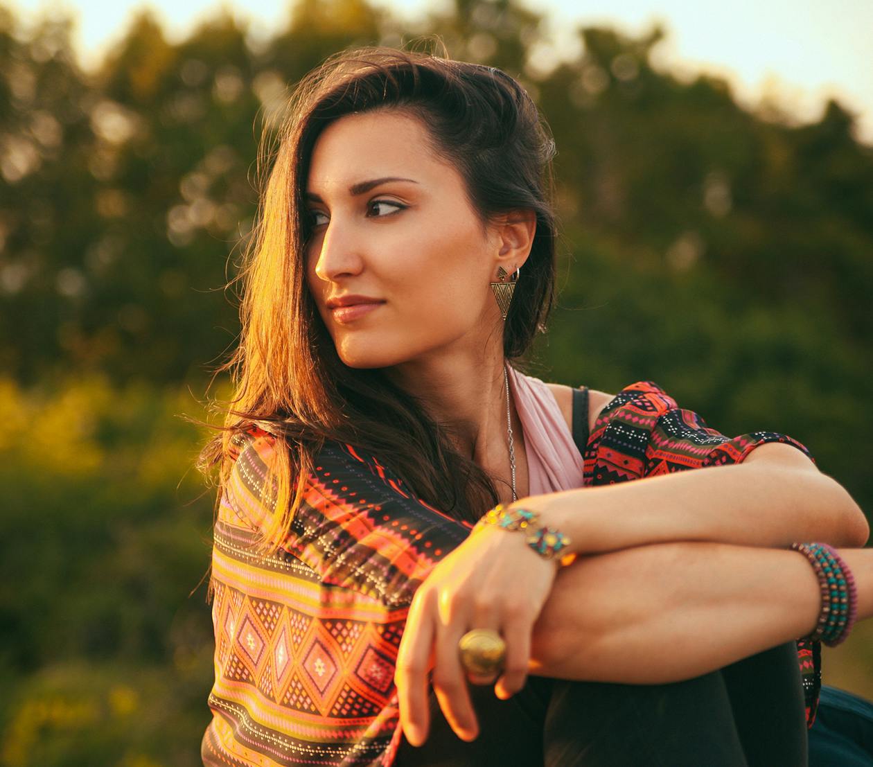 Woman with brown hair and orange printed top