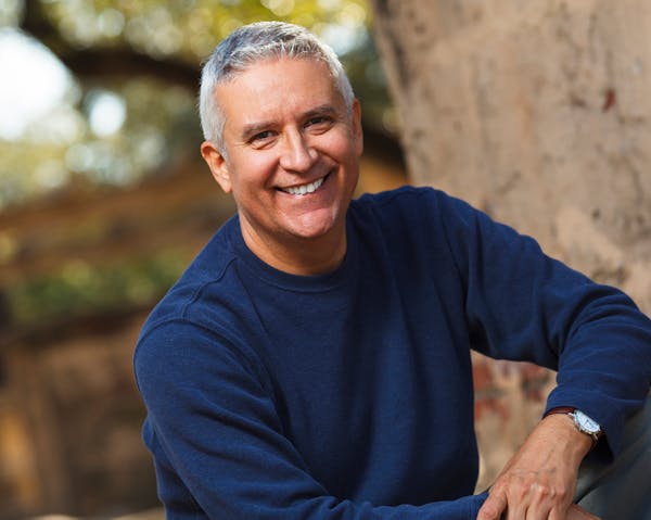 older, white haired man smiling