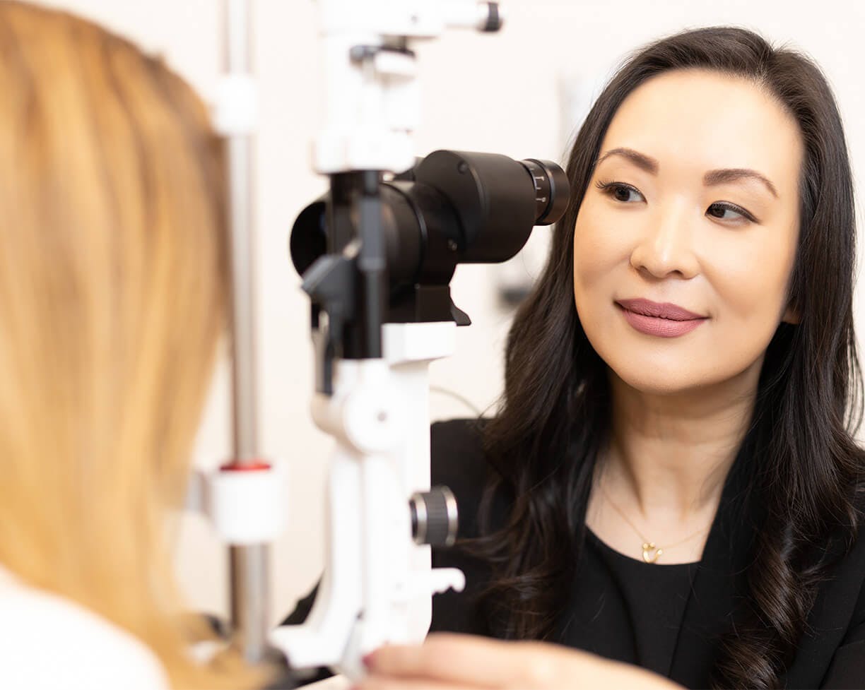 Dr. Vargason looking at a patient's eyes through a tool