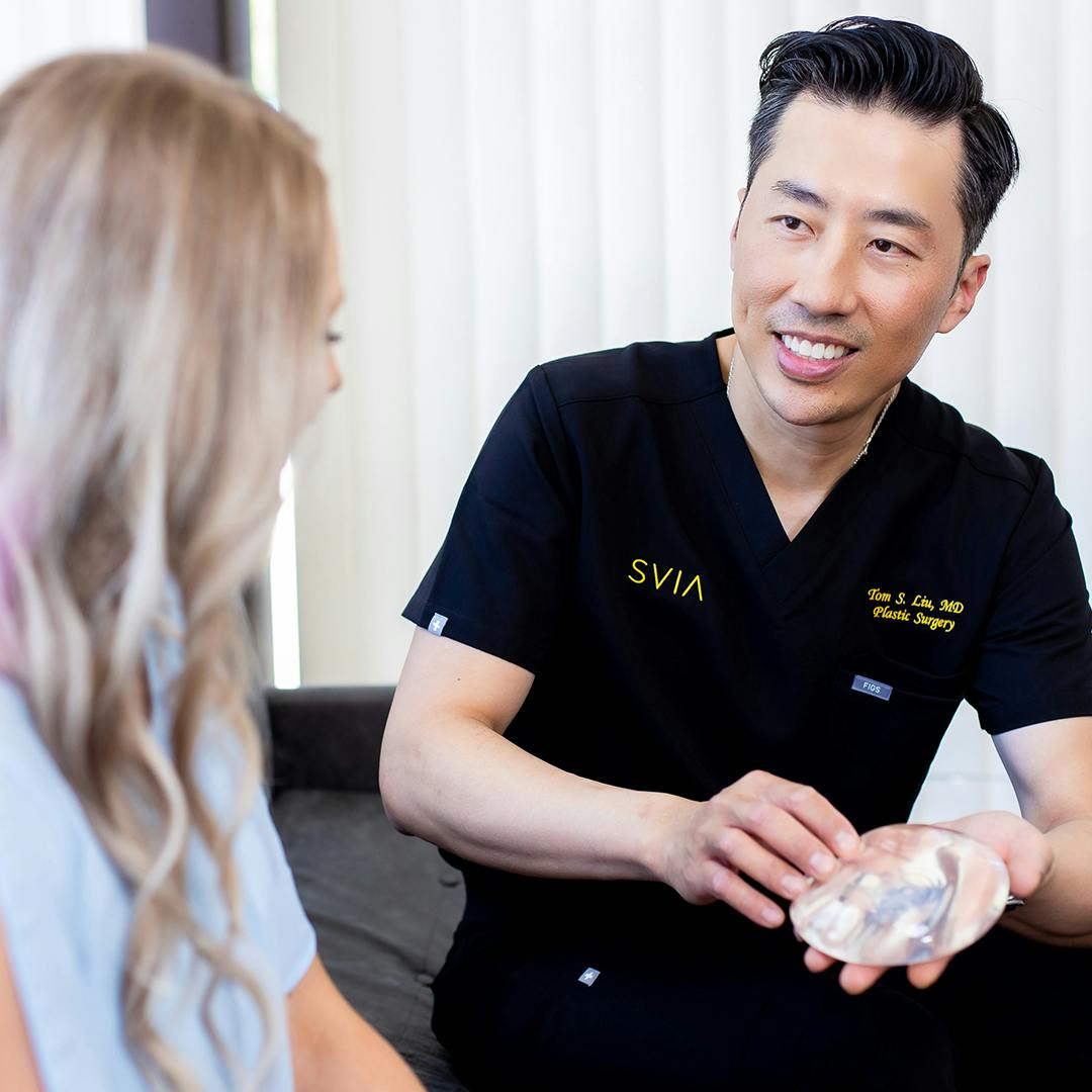 Dr. Tom S. Liu talking to patient about implants