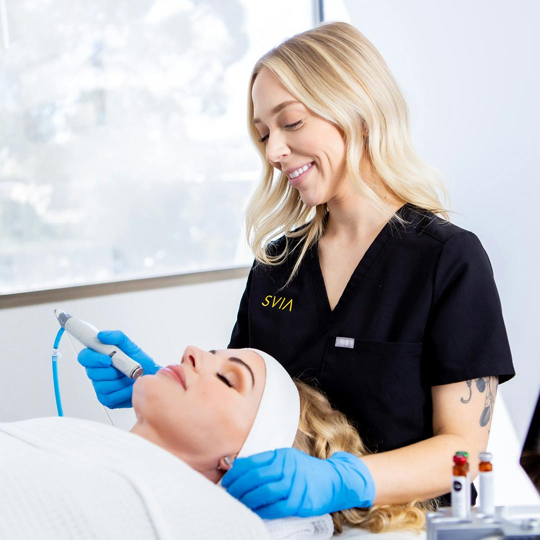 Woman receiving facial treatment