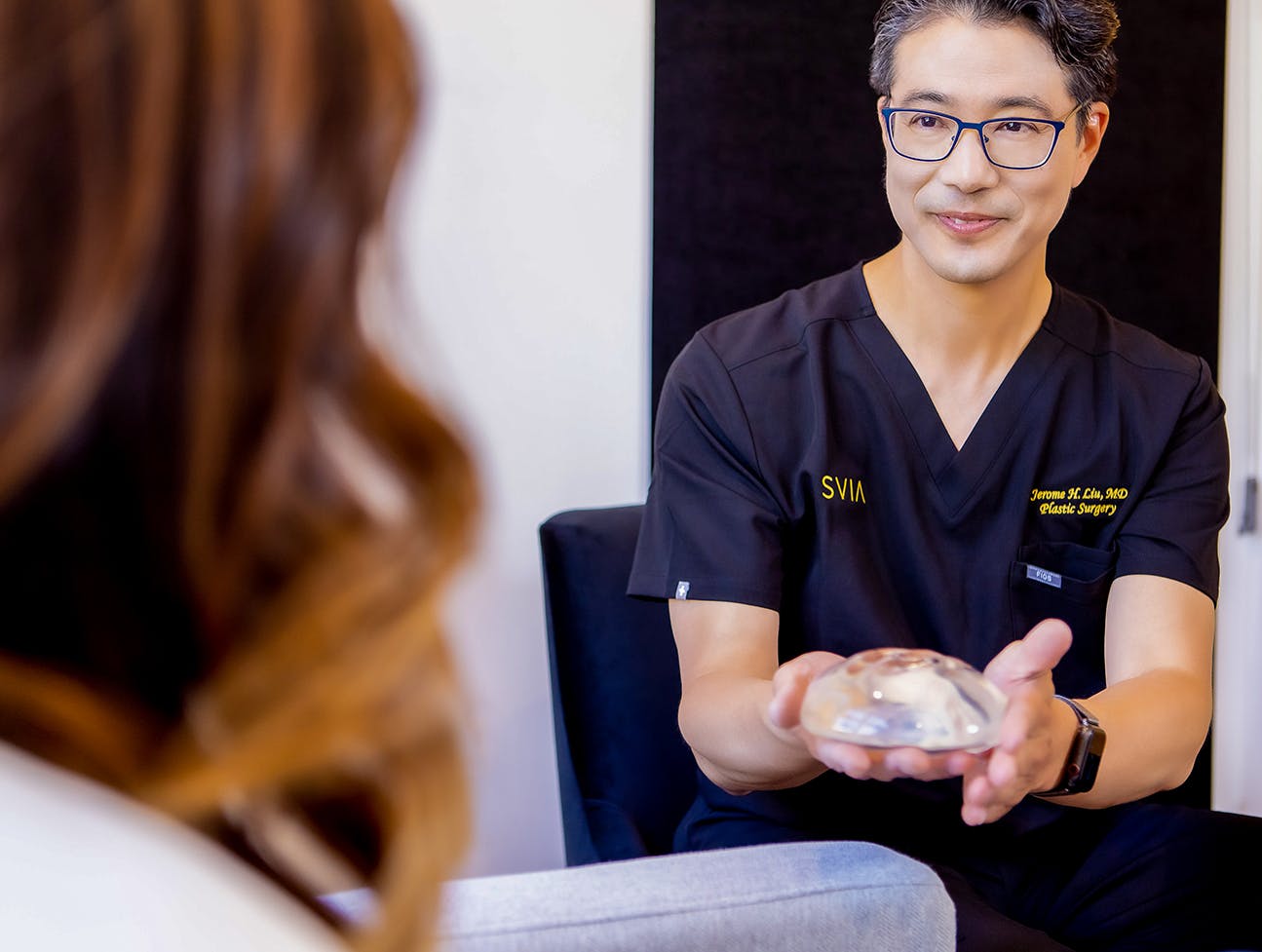 Dr. Jerome H. Liu talking to patient about implants