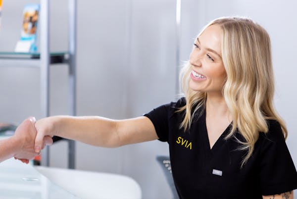 Staff at SVIA shaking hands with patient