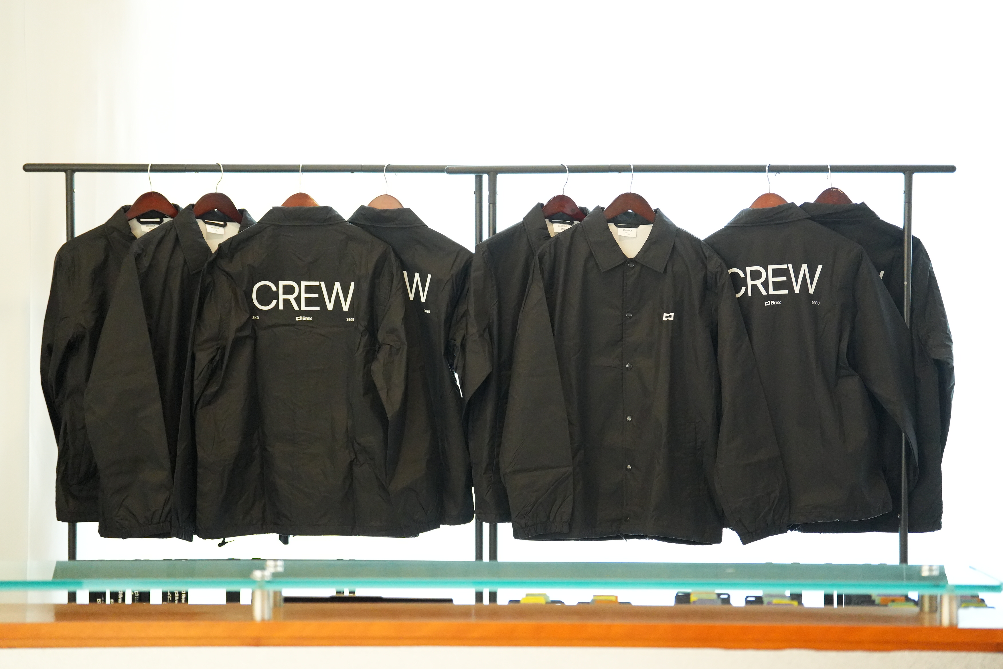 Brex SKO 2026 custom coach jackets on display rack