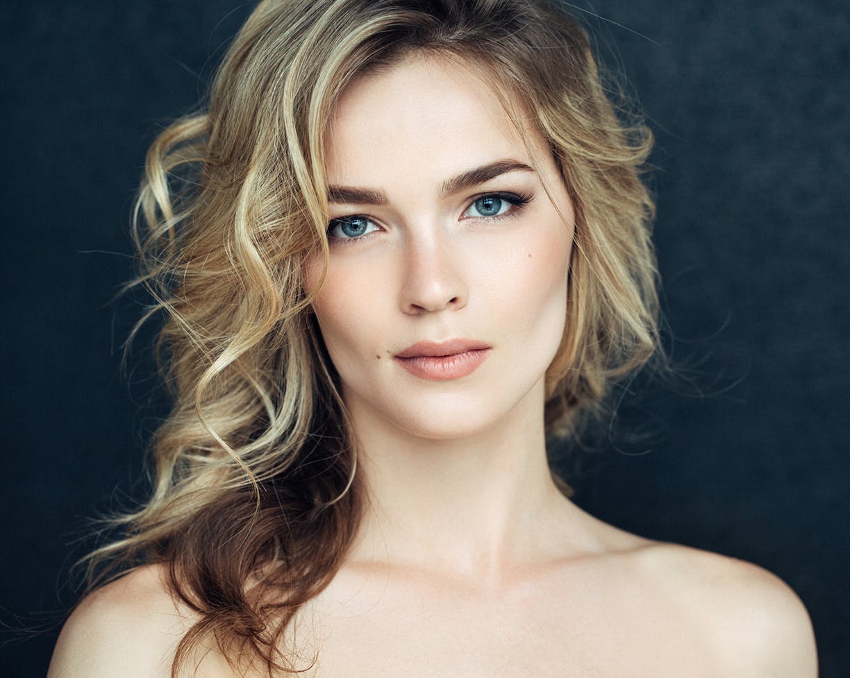 Woman with curly hair looking at camera