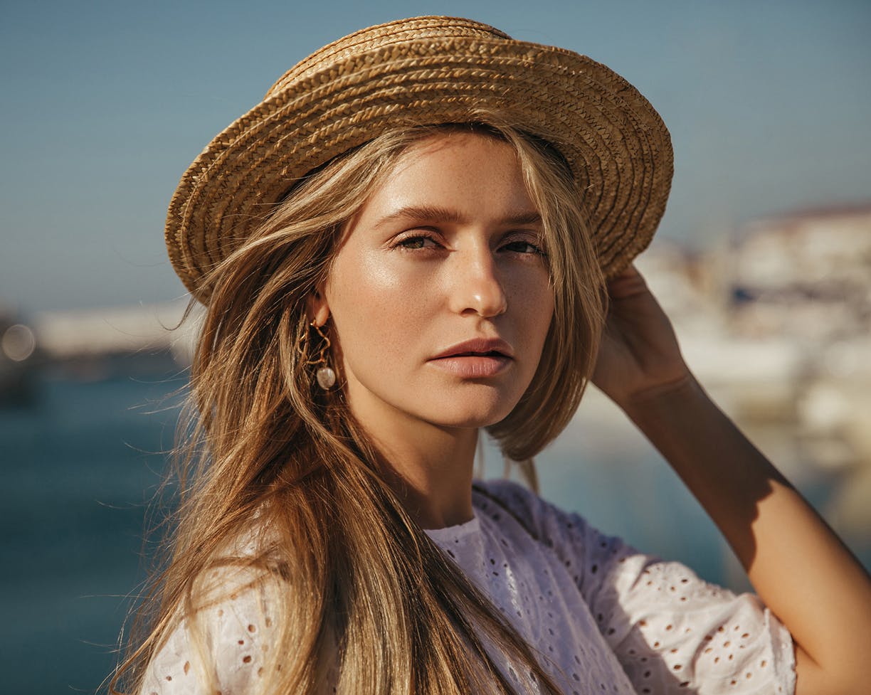 Woman wearing a hat standing outside