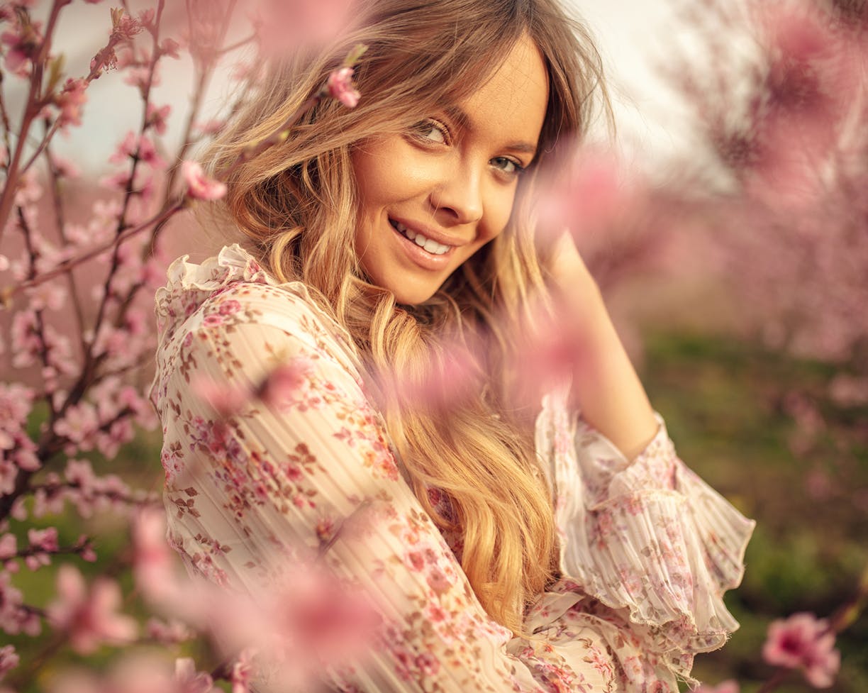 Woman surrounded by cherry blossoms
