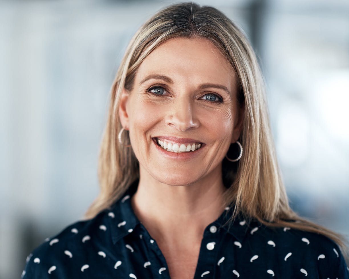 Woman in navy blue and white shirt smiling