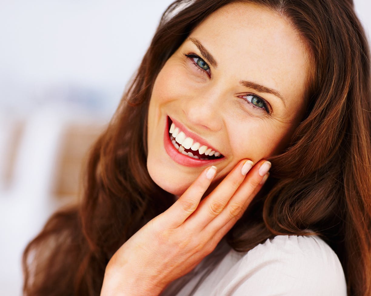 Woman holding her face and laughing