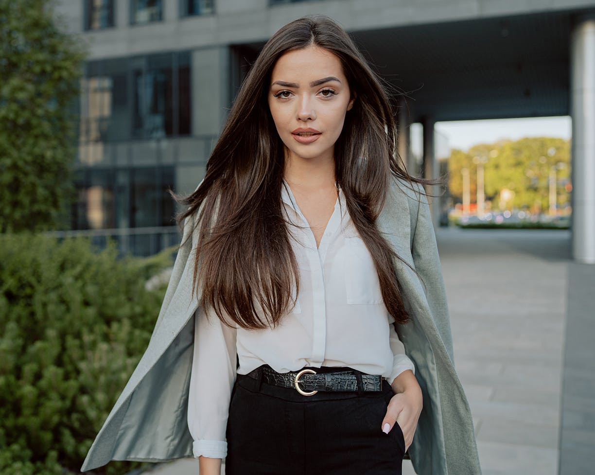 Classy brunette business woman standing outside