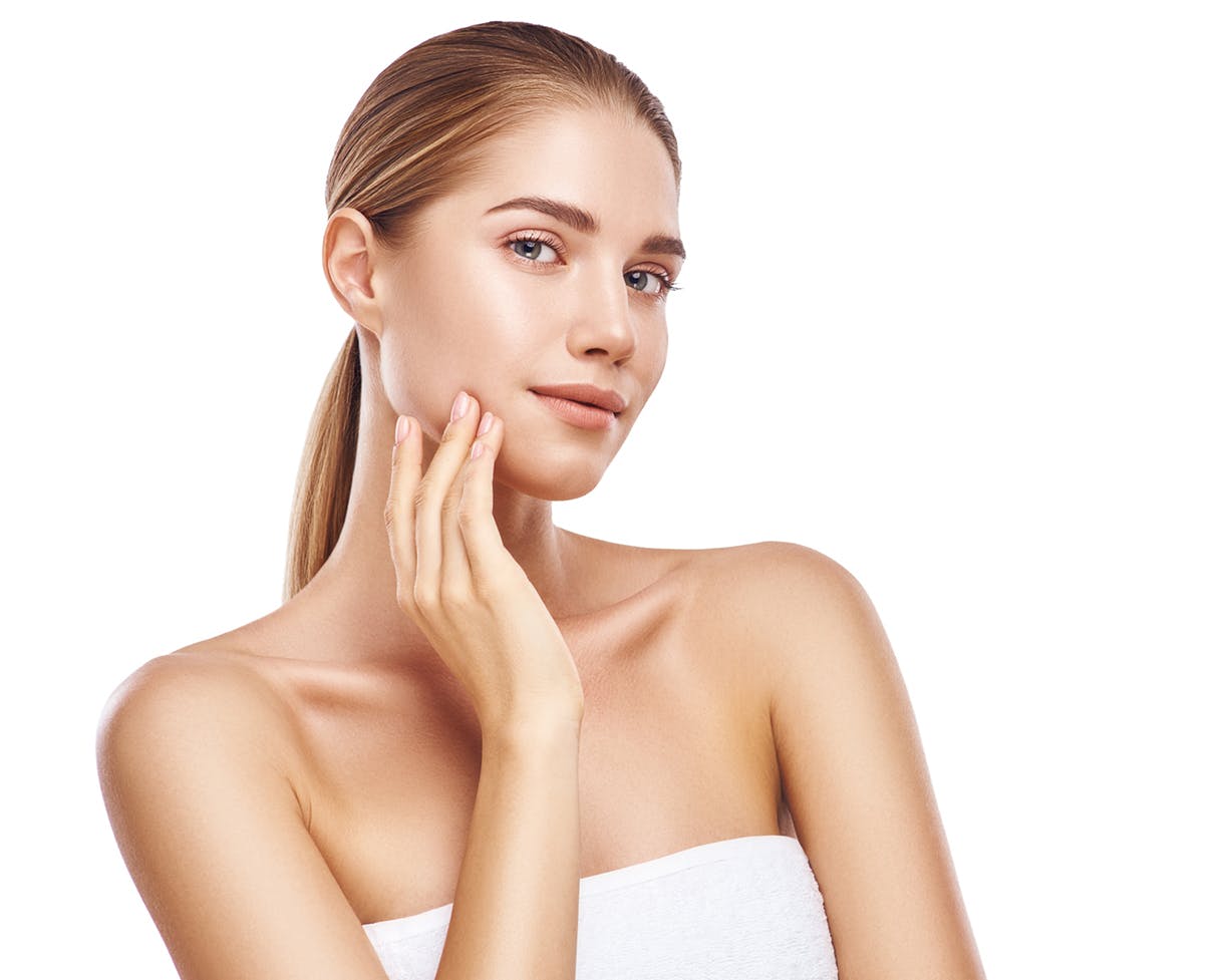 Woman in a white top touching side of her face