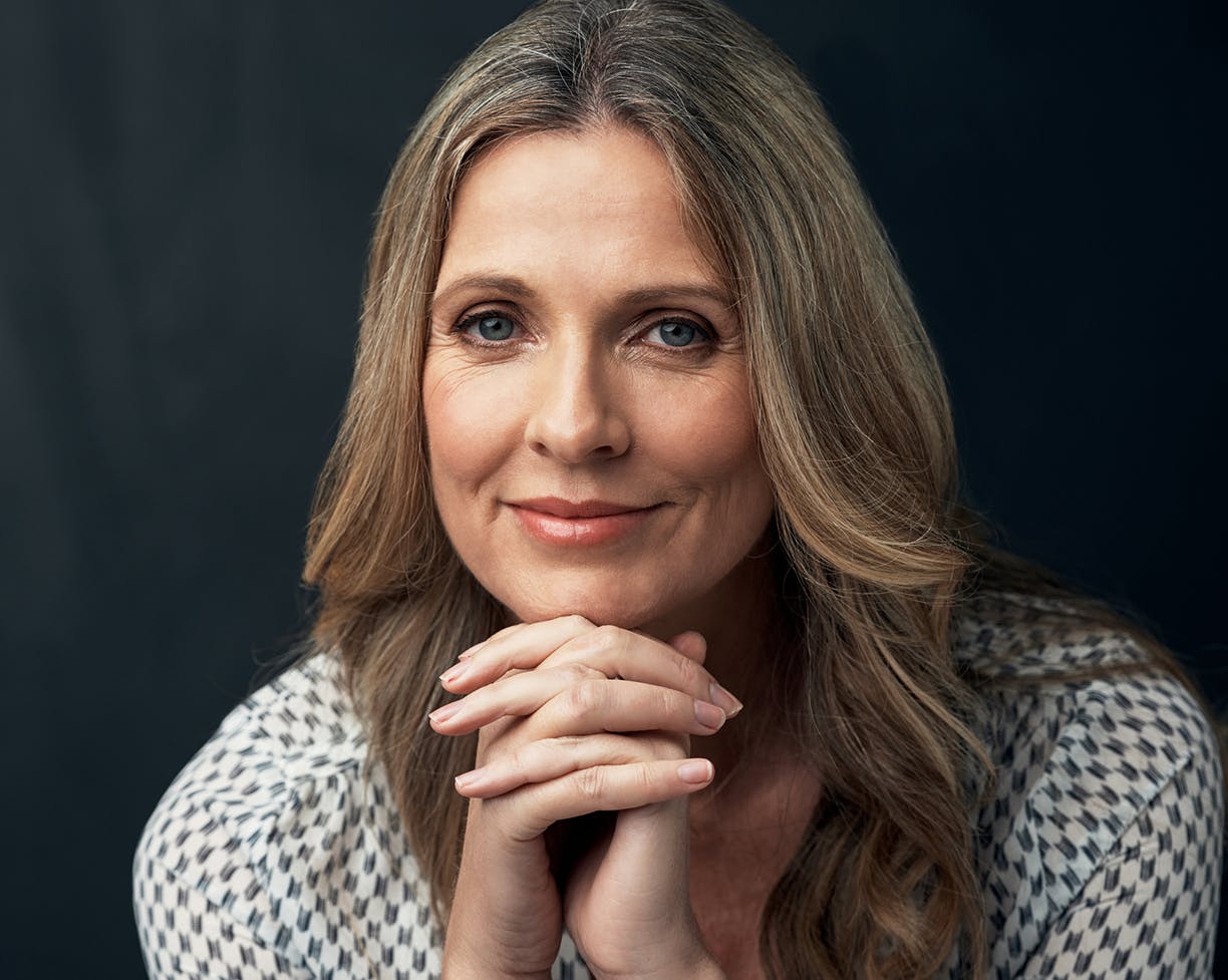Woman with folded hands to her chin