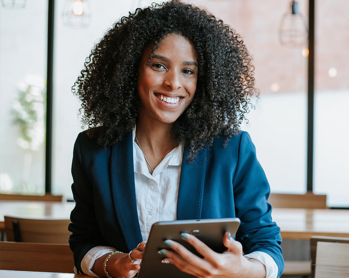 Woman holding an iPad smiling