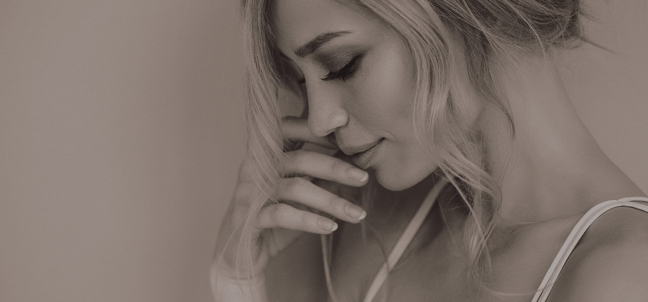 Side profile of a woman touching her face
