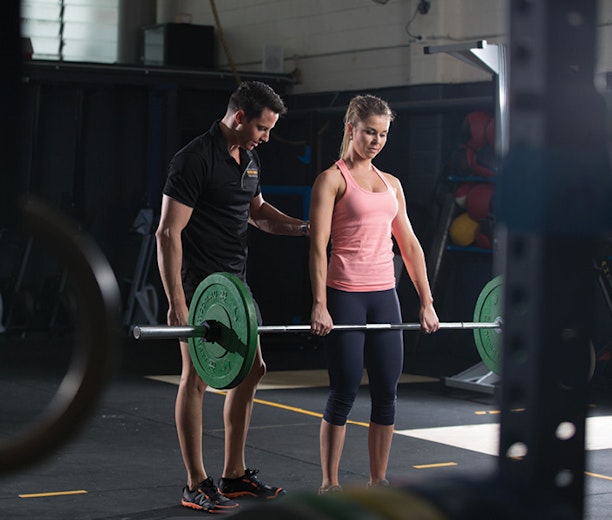 Male training female with weights