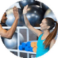Male and female high five in gym