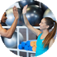 Male and female high five in gym