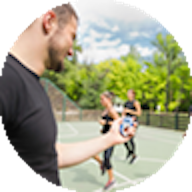 Male teaching a fitness group outside