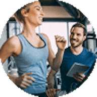 Gym Instructor training a client