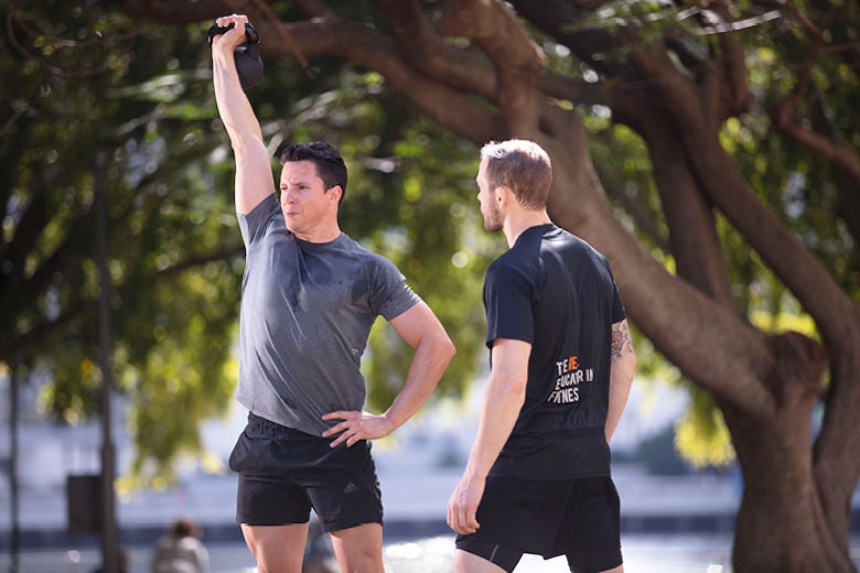 PT training a client with a kettlebell