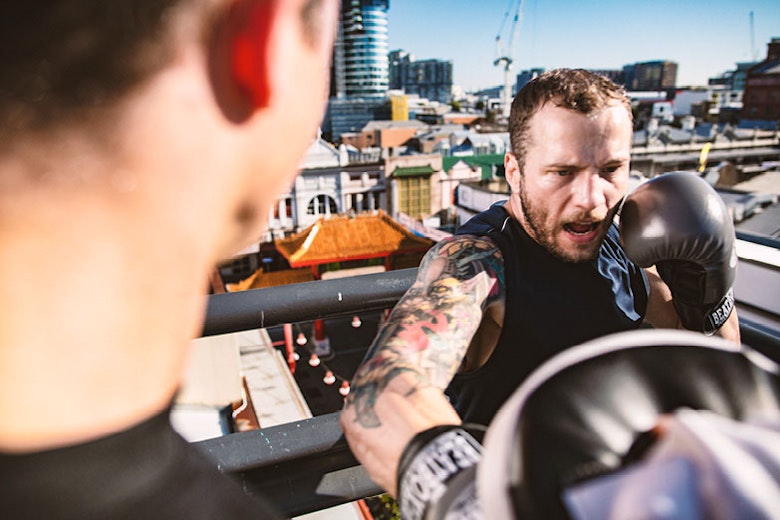 Trainer with client boxing on a rooftop